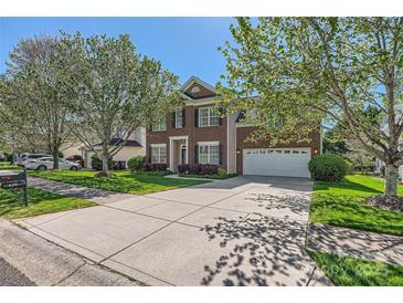 Charming two-story brick home with a well-manicured lawn and a spacious driveway at 639 Lorain Nw Ave, Concord, NC 28027