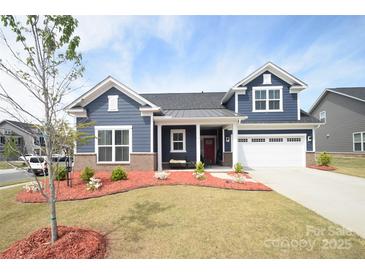 Charming two-story home with manicured lawn and inviting front porch at 705 Hinterland Ln, Matthews, NC 28104