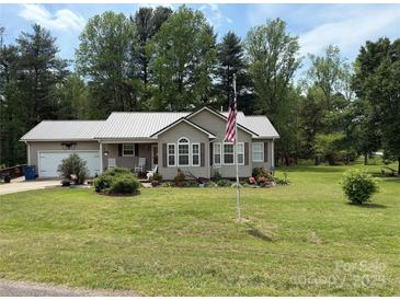 Charming single-story home featuring a metal roof, lush lawn, and a welcoming front porch at 1025 Bee Line Ln, Salisbury, NC 28147