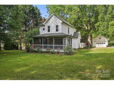Charming two-story home with a screened-in porch and mature trees at 105 Horsestable Ct, Mooresville, NC 28115