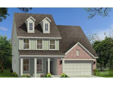Charming two-story home featuring a brick and siding exterior, dormer windows, and a two-car garage at 105 Nighthawk Trl # 20, Mooresville, NC 28115