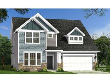 Charming two-story home with stone accents, gray siding, a front-facing garage, and a well-manicured lawn at 107 Nighthawk Trl # 21, Mooresville, NC 28115