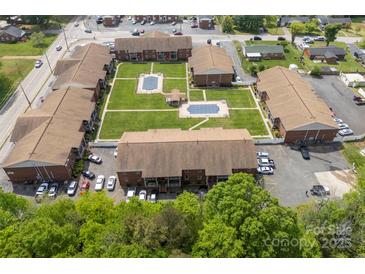 This aerial view reveals the community's well-maintained lawn, swimming pool, ample parking, and convenient location at 123 Carriage House Dr, Kannapolis, NC 28081