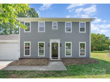 Charming two-story home with gray siding, white trim, and well-maintained landscaping at 1640 English Knoll Dr, Matthews, NC 28105