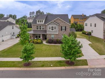 Beautiful two-story home featuring a manicured lawn and charming curb appeal at 16711 Monocacy Blvd, Huntersville, NC 28078