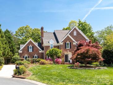 Beautiful brick two-story home with mature landscaping and classic architectural details at 216 Liriope Ct, Matthews, NC 28105