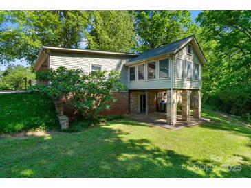 Unique home exterior featuring a sunroom on stilts and outdoor patio at 237 Fea Ln, Iron Station, NC 28080