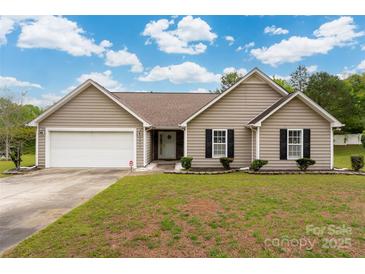 Charming single-story home with a well-manicured lawn, attached garage, and classic curb appeal at 2412 Laura Dr, Charlotte, NC 28212