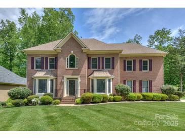 Elegant two-story brick home with manicured lawn and lovely landscaping at 3119 Castlemaine Dr, Charlotte, NC 28269