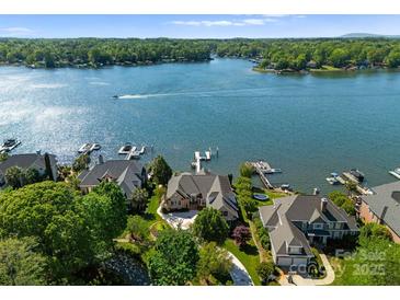 Stunning aerial view of lakefront homes with private docks on a sunny day at 3507 Governors Island Dr, Denver, NC 28037