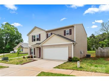 Two-story home with beige siding, white garage door, and red shutters sits under a blue sky at 355 Jared Steel Ln, Salisbury, NC 28146