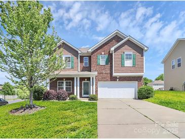 Charming two-story home featuring brick and wood accents, complemented by a well-manicured lawn and a two-car garage at 5146 Elementary View Dr, Charlotte, NC 28269