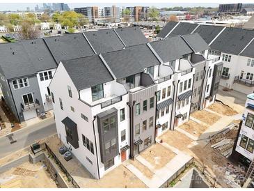 Modern townhome exteriors featuring a mix of white and gray siding with black trim at 6005 Countess Dr # 49, Charlotte, NC 28217