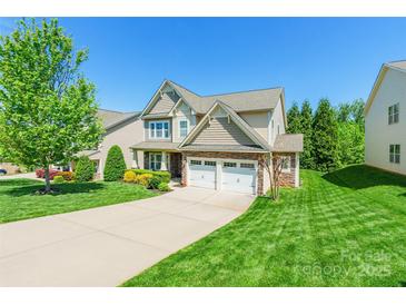 Beautiful two-story home with stone accents, well-kept lawn, and a spacious driveway at 924 Forbes Rd, Fort Mill, SC 29707