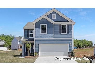 Charming two-story home with a well-maintained lawn and attached two-car garage at 143 Stonewater Dr # 13P, Red Cross, NC 28129