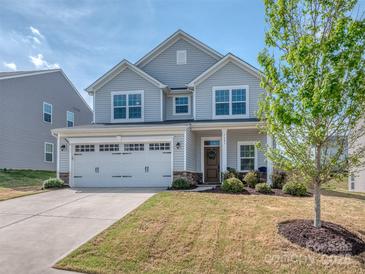Charming two-story home featuring a two-car garage, well-manicured lawn, and traditional architectural details at 1607 Tundra Ln, Denver, NC 28037
