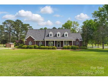 Stunning brick home featuring dormer windows, manicured lawn, and mature trees at 172 Fairway Cir, Rock Hill, SC 29730