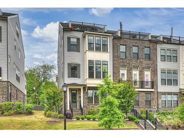 Beautiful townhome with a mix of gray siding and brick, a rooftop terrace, manicured landscaping, and inviting curb appeal at 2541 Kenmore Ave, Charlotte, NC 28204