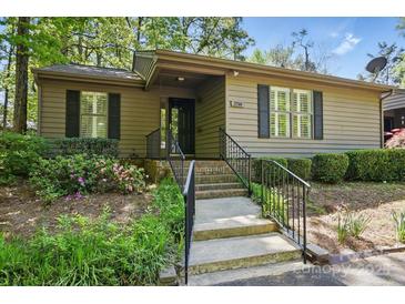 Charming single-story home featuring neutral siding, black shutters, and well-maintained landscaping at 2710 Red Bud Ln, Fort Mill, SC 29715