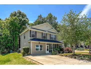 Charming two-story home with a welcoming front porch and well-maintained landscaping at 4825 Samuel Richard St, Kannapolis, NC 28083