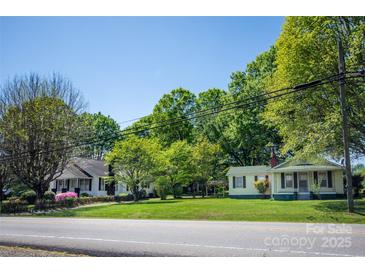 Charming street view of homes with lush lawns and mature trees on a sunny day at 495&501 Turnersburg Hwy, Statesville, NC 28625