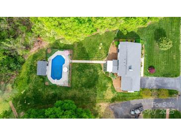Aerial view of the home showcasing the pool, landscaping, and large backyard at 5486 Suttlemyre Ln, Hickory, NC 28601