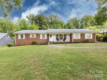 Charming brick ranch home with a well-manicured lawn and inviting front porch at 6616 Williams Rd, Charlotte, NC 28215