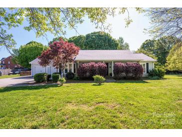 Charming single-story home with a well-manicured lawn and mature landscaping creating curb appeal at 695 Linwood Rd, Mooresville, NC 28115