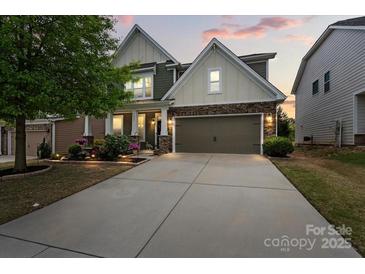 Charming two-story home with stone accents, a two-car garage, and a well-manicured front yard at 7039 Chrysanthemum Rd, Lancaster, SC 29720