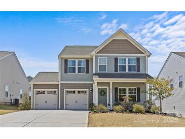 Charming two-story home featuring a two-car garage, landscaped yard, and inviting curb appeal at 1062 River Haven Sw Ave, Concord, NC 28025