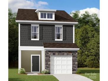 Charming two-story home with stone accents, a gray facade, and a pristine white garage door at 1115 Overbrook Pl, Wingate, NC 28174