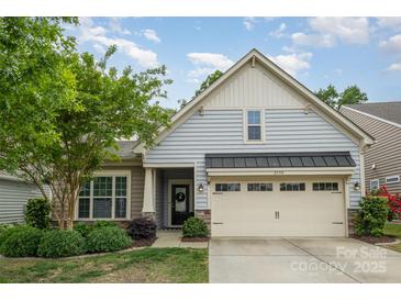 Charming home featuring light blue siding, a two car garage, and a well manicured front yard at 2158 Winhall Rd, Fort Mill, SC 29715