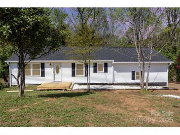 Charming single-story home with white siding, black shutters, and a inviting front porch at 221 Belton Ave, Mount Holly, NC 28120