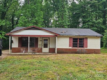 Single story home with a covered front porch and brick base sitting on a large lot at 4406 Valeview Ln, Charlotte, NC 28269