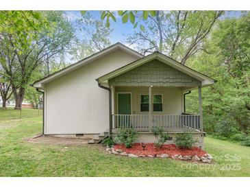 Charming home with a covered porch and a well-manicured lawn at 500 3Rd St, Stanley, NC 28164