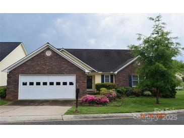 Charming single-story home with brick accents, a two-car garage, and blooming flowers at 625 Court Side Dr, Salisbury, NC 28147