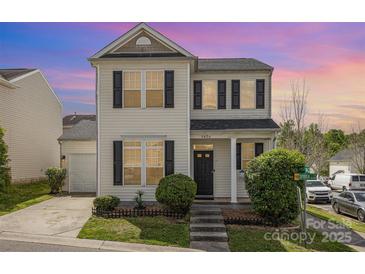 Charming two-story home features manicured lawn, black shutters, and neutral siding on a corner lot at 8424 Spirea Ct, Charlotte, NC 28215
