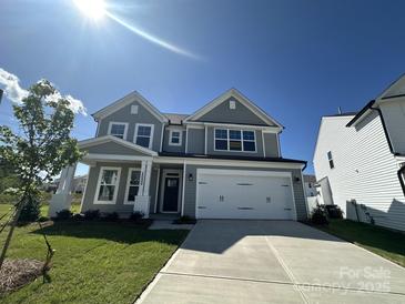 Charming two-story home with a two-car garage, manicured lawn, and classic architectural details at 2020 Embassy Ct # 48, Charlotte, NC 28213