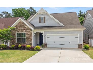 Charming home exterior featuring a stone facade, two-car garage, and well-maintained landscaping at 536 Rustlewood Way, Rock Hill, SC 29732