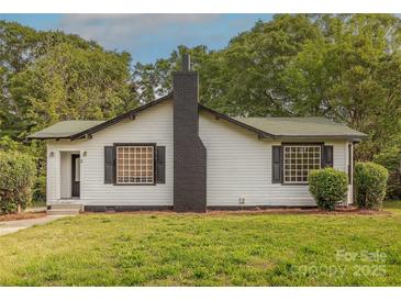 Charming single-story home featuring a black brick chimney and complemented by mature trees at 8 Bolt Dr, Shelby, NC 28150