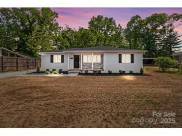 Inviting home featuring manicured landscaping with a fresh, vibrant lawn and mature trees enhancing its charm at 1306 Klondale Ave, Kannapolis, NC 28081
