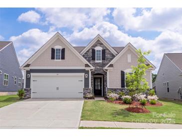 Charming, new construction home with stone accents, well-manicured lawn and a two-car garage at 167 White Apple Way, Statesville, NC 28625