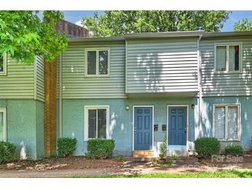 Charming townhome featuring blue doors, light siding, and well-maintained landscaping at 1931 Mereview Ct # 46, Charlotte, NC 28210