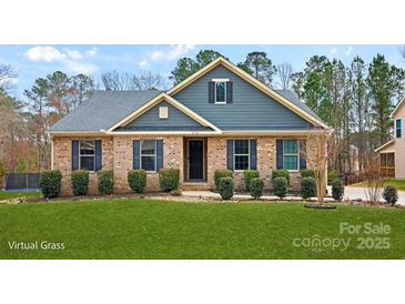 Charming brick home with blue siding and shutters, complemented by lush green lawn and landscaping at 2322 Morrison Rd, York, SC 29745