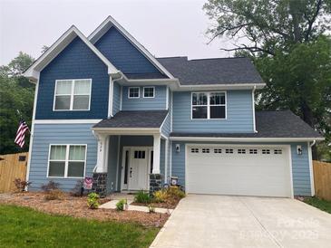 Charming two-story home with blue siding, black roof, a two-car garage and a well-maintained front lawn at 5733 Selkirk Dr, Hickory, NC 28601