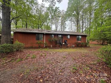 Charming single-story home featuring a beautiful natural backdrop with mature trees at 5950 Lake Wylie Rd, Clover, SC 29710