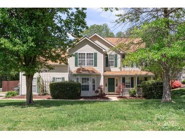 Charming two-story home with a well-maintained lawn and mature trees providing shade at 101 Canopy Ct, Mooresville, NC 28115