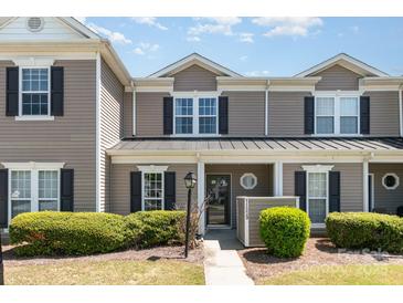 Charming two-story townhome with neutral siding, black shutters, and well-maintained landscaping at 11229 Lions Mane St, Charlotte, NC 28273