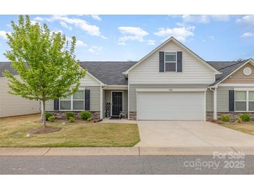 Charming home featuring a 2-car garage, landscaped yard, and inviting front entrance at 1125 Silvertrace Dr, Salisbury, NC 28144