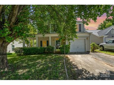 Charming two-story home with a welcoming front porch and well-maintained landscaping offers great curb appeal at 12016 Gemstone Ct, Charlotte, NC 28269